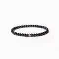 Simple geometric agate bracelet with round and square 4mm beads on a wrist.