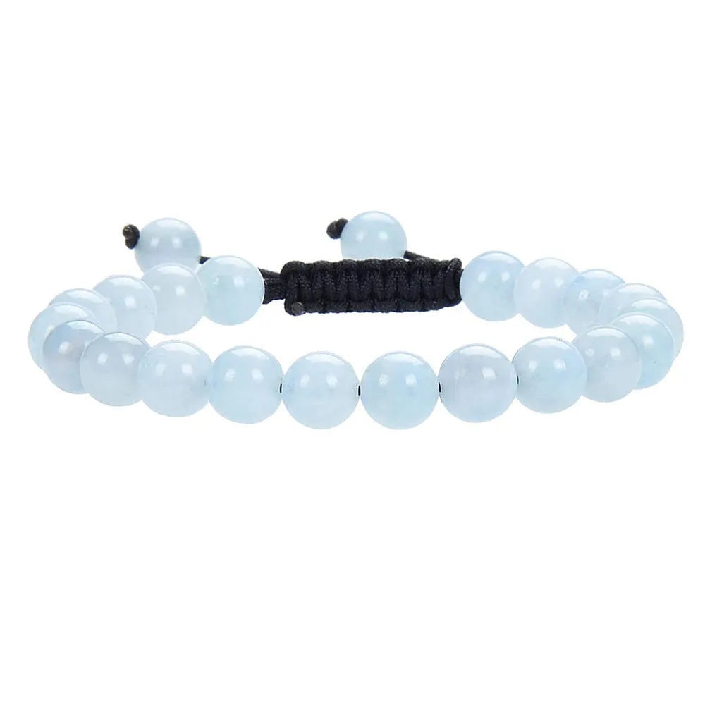 Close-up of a women's flat knot braided aquamarine bracelet showing hand-woven texture and geometry patterns.