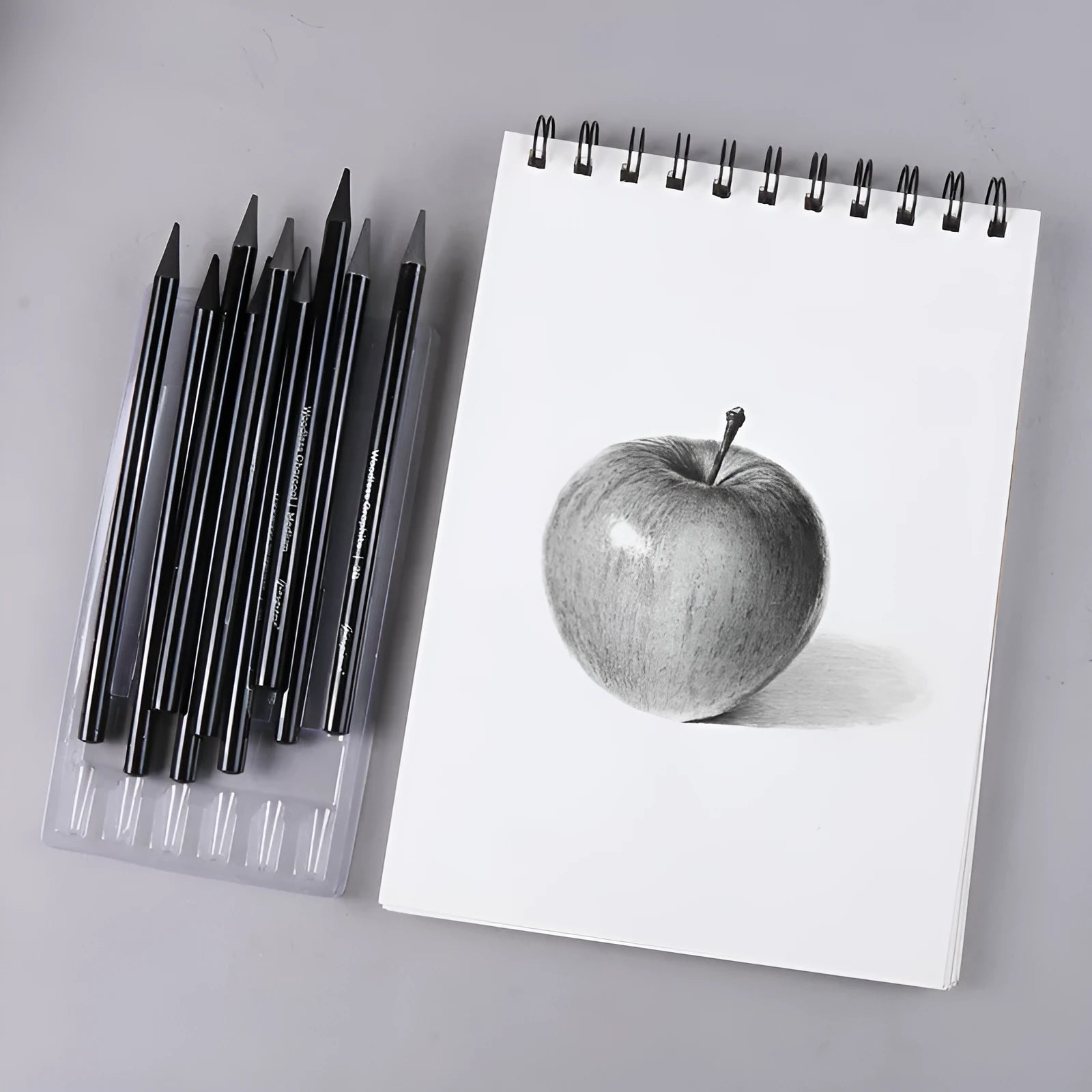 Carbonized pencil set showing six graphite and three carbonized drawing pencils with wooden casings on suction card packaging