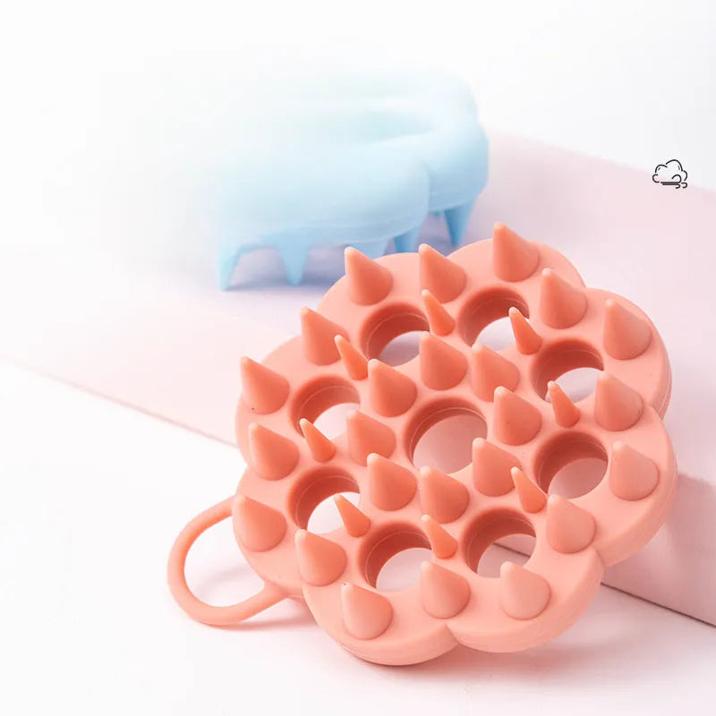 Silicone pet grooming brush in multiple colours for dogs and cats, showing flexible bristles.