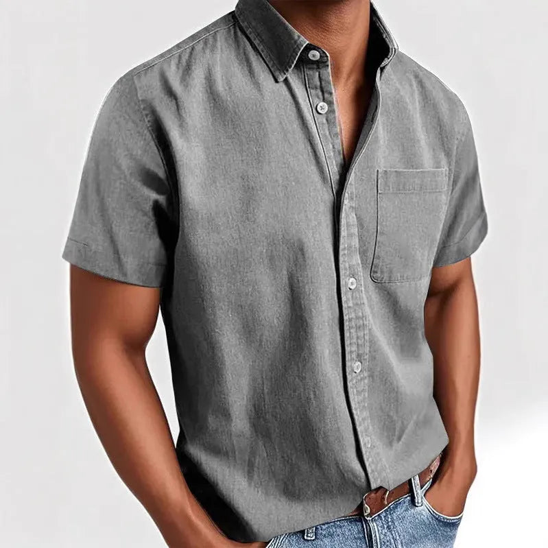 Men's solid colour short sleeve polo shirt with a chest pocket and polo collar on a hanger.