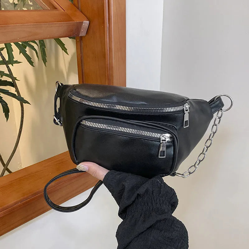 Women's soft PU leather shoulder bag with chain detail in black against a plain background