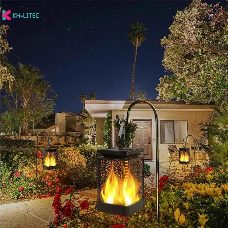 Four black solar-powered hanging torch lights with flame-effect LEDs for outdoor garden decoration.