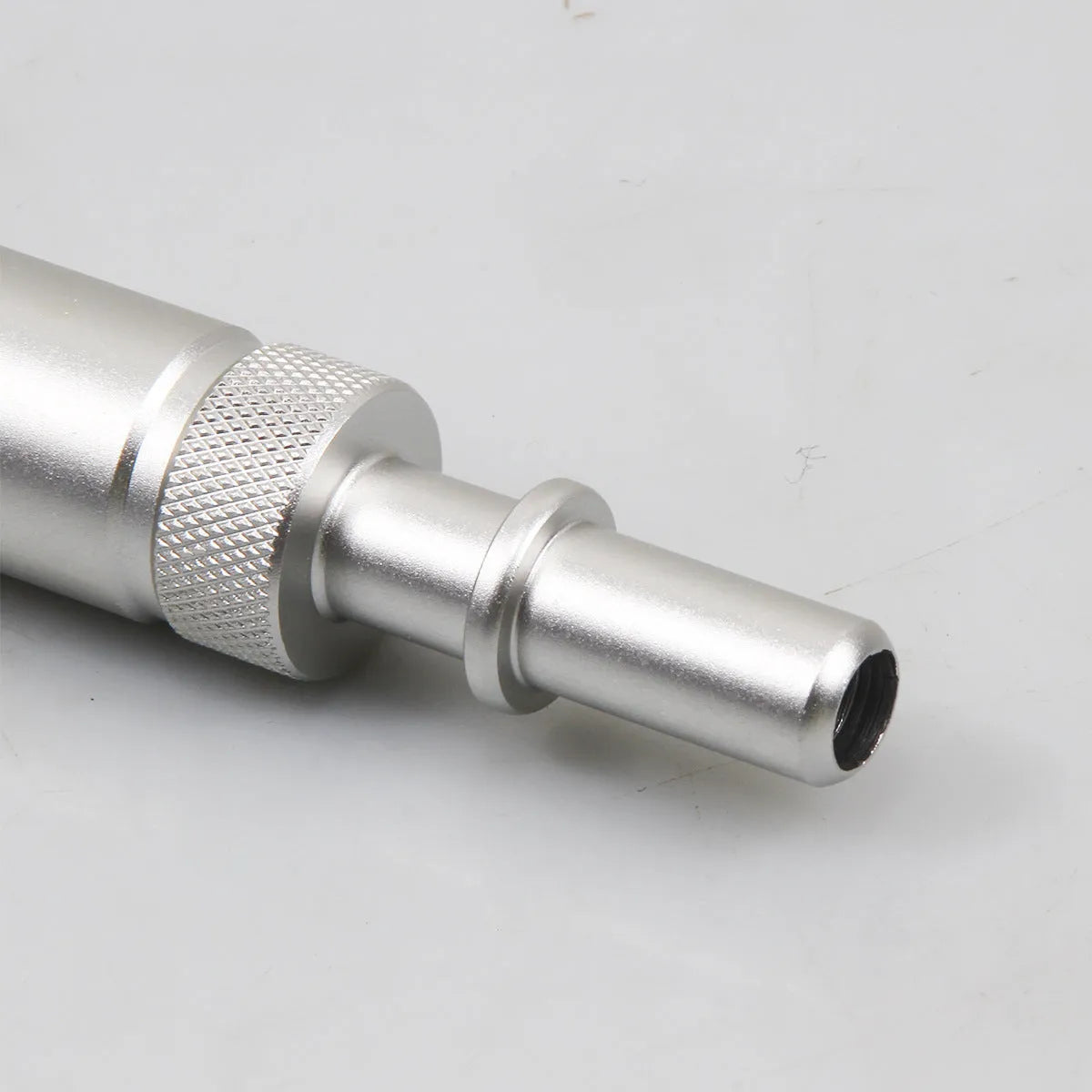 Silver metal transmission refuelling joint tool for VAS6262-9 on a workshop bench.