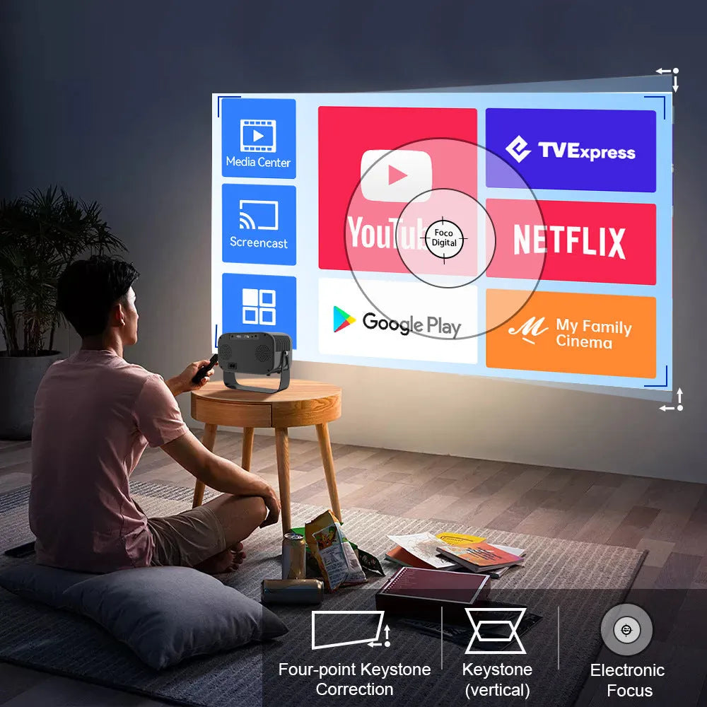 Black portable HD projector with remote control on desk