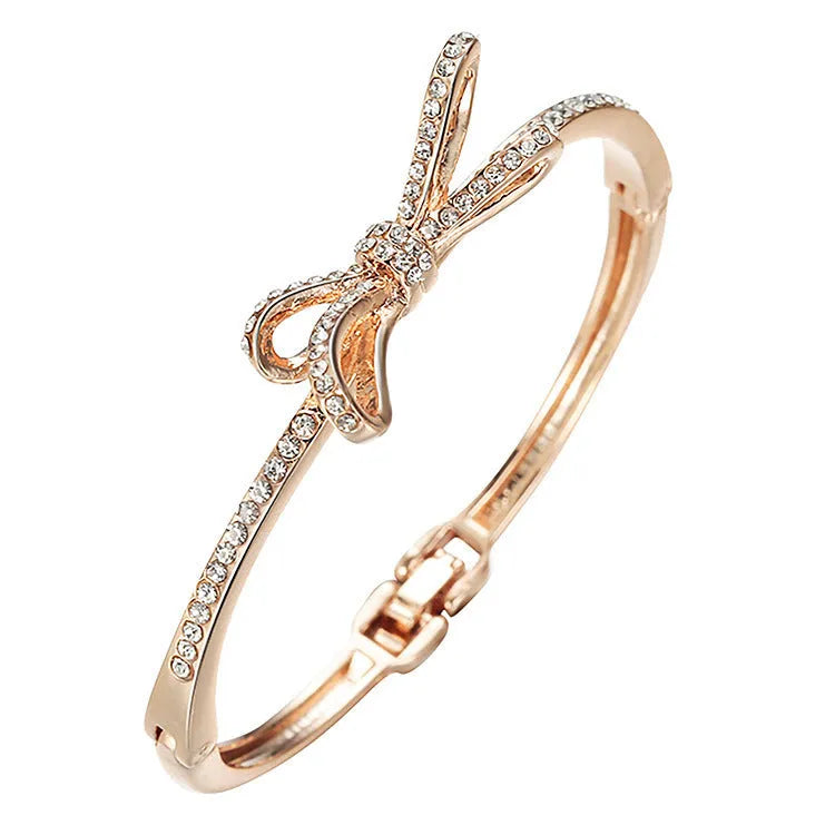 Women's rose gold bow bracelet made from electroplated copper with a diamond feature