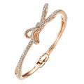 Women's rose gold bow bracelet made from electroplated copper with a diamond feature