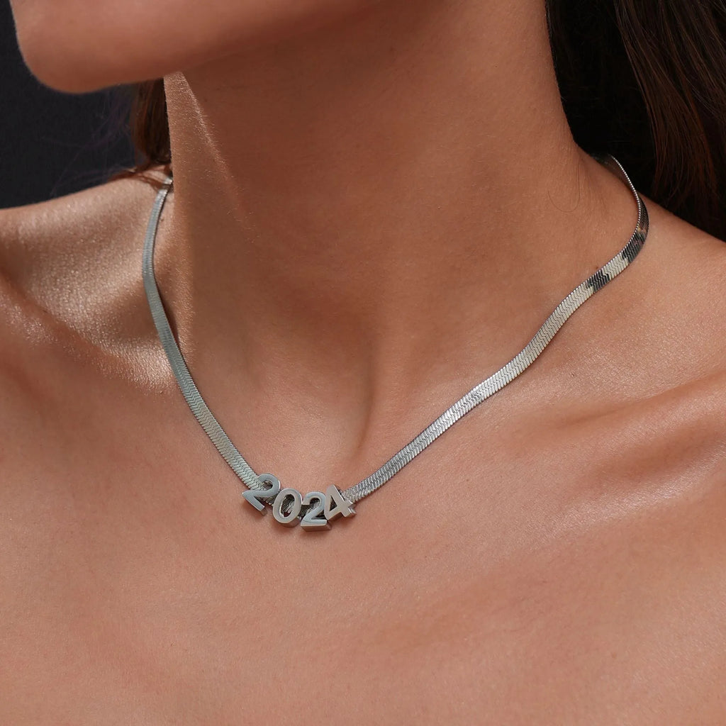Gold titanium steel necklace with a letter A pendant on a blade chain.