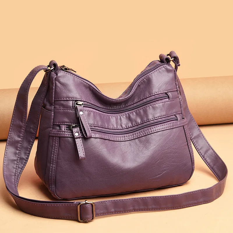 Real washed leather crossbody bag in solid colour with soft handle and slit pocket