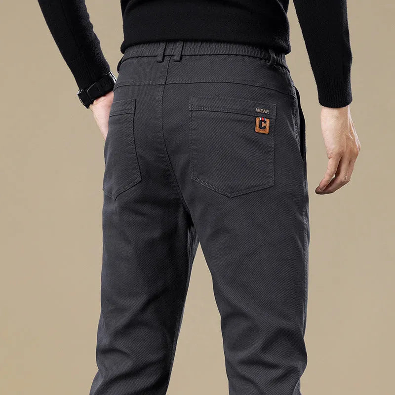 Men's fleece-lined slim fit tapered casual pants in black cotton fabric