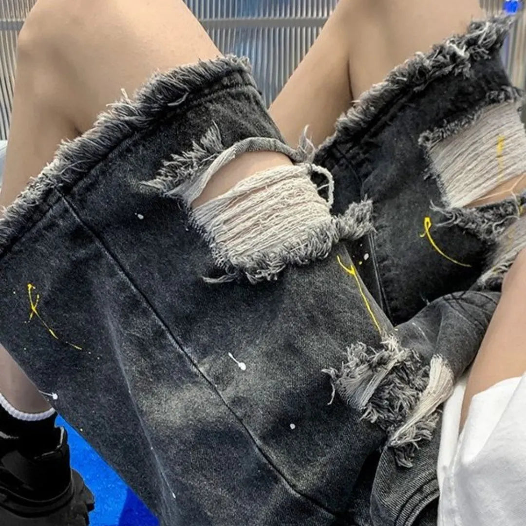 Man wearing loose-fit light blue water-washed denim shorts with hole details, for summer casual street style.