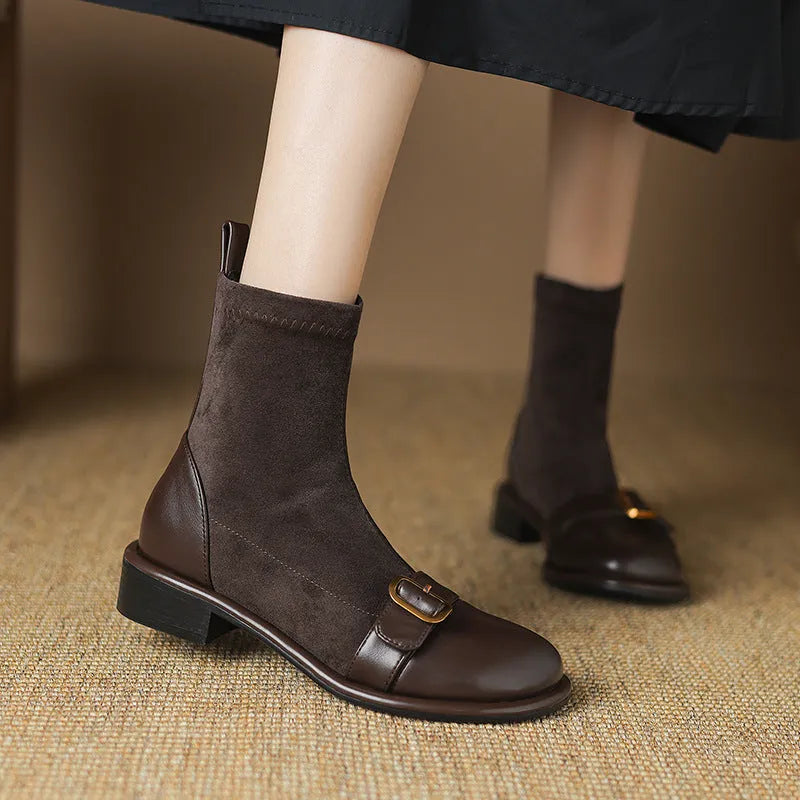 Women's black low heel Martin boot with lace-up front and decorative buckle stitching on a round toe.