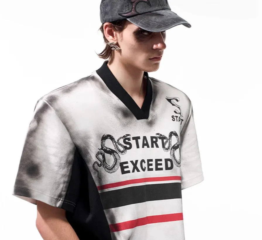 Women's V-neck short sleeve top with black and white letter snake pattern print and padded shoulders.