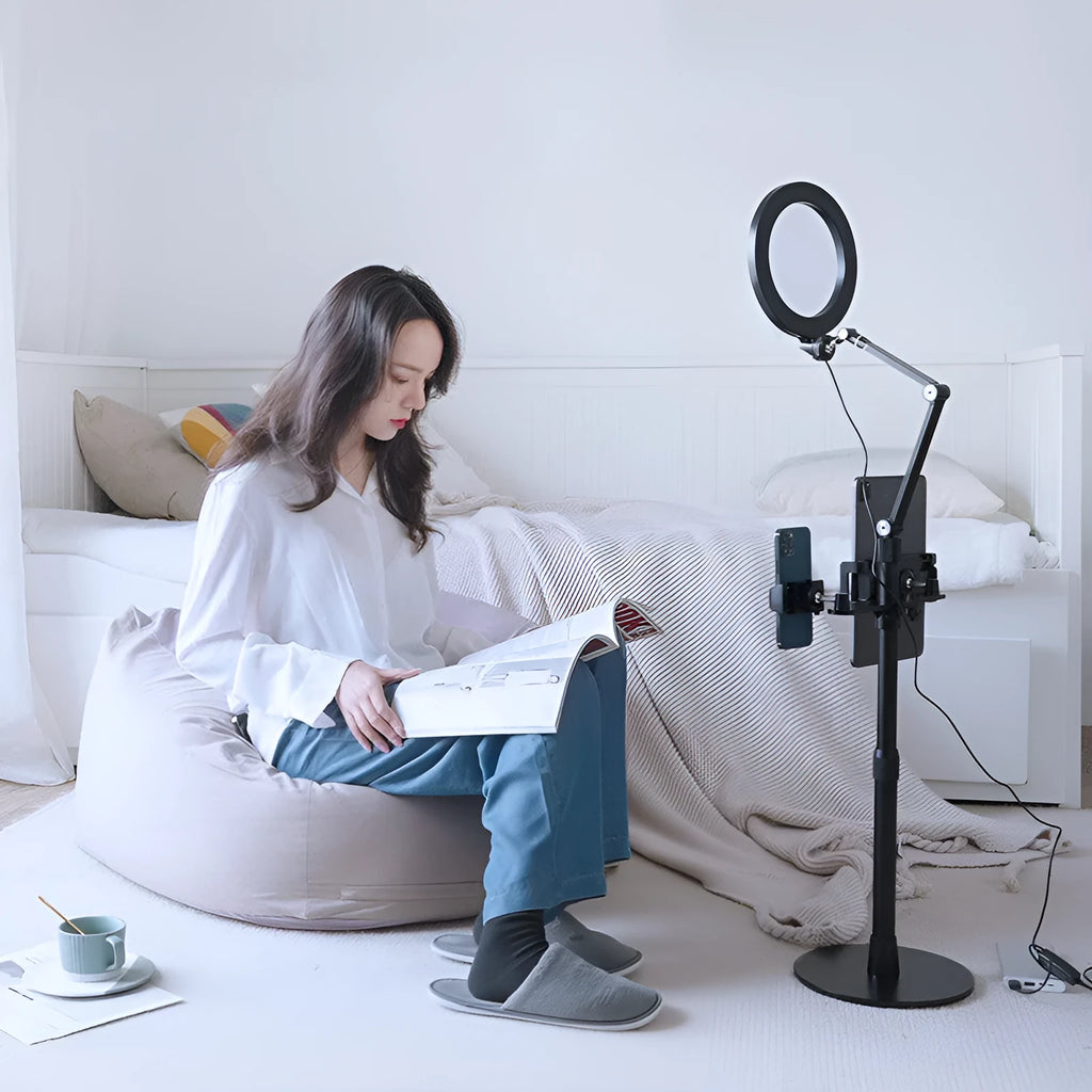 Black vertical floor stand with LED fill light holding mobile phone for filming
