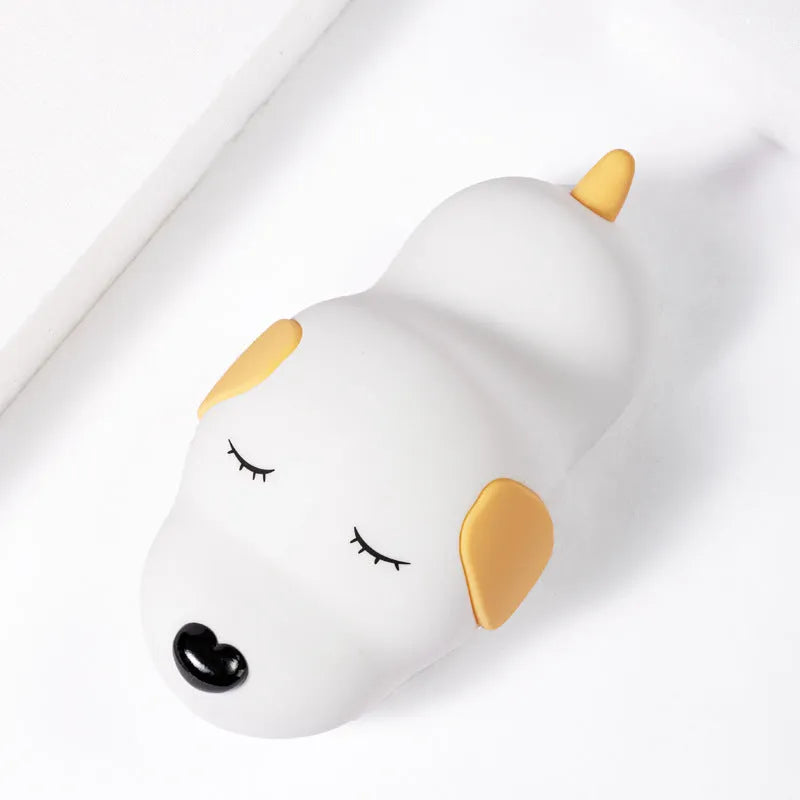 A two-tone cartoon dog-shaped silicone night lamp with a USB charging port.