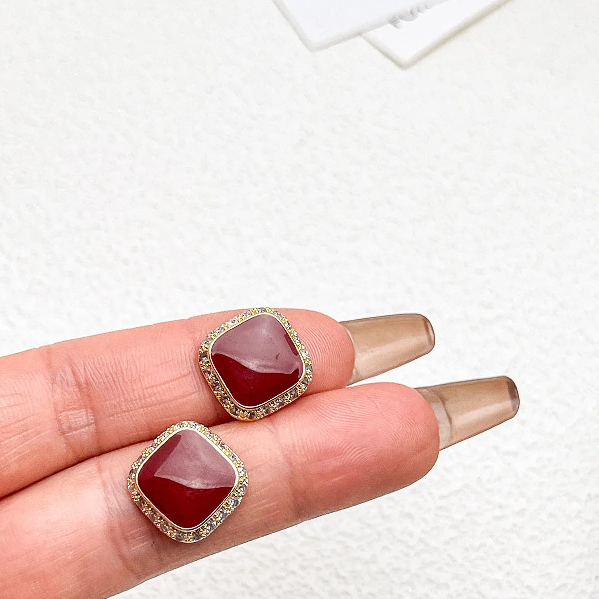 A pair of retro red square geometric alloy earrings with an inlaid design detail.