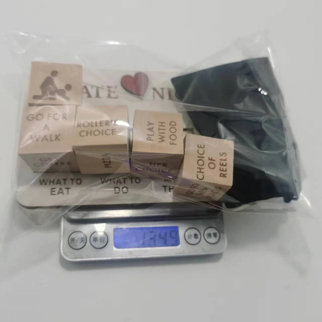 Wooden date night dice game set for couples showing five dice, a wooden planner board and a black storage bag.