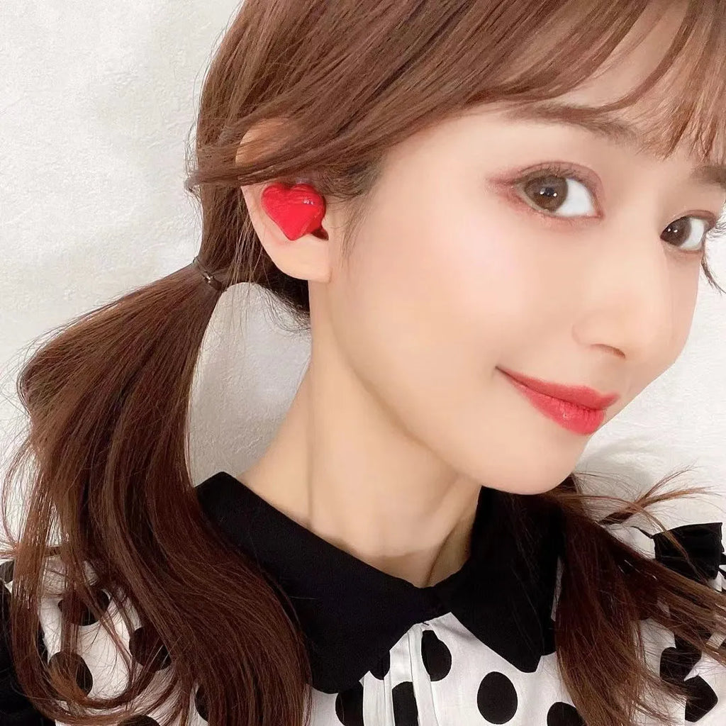 Heart-shaped wireless Bluetooth headphones in red or pink colours with earplug design