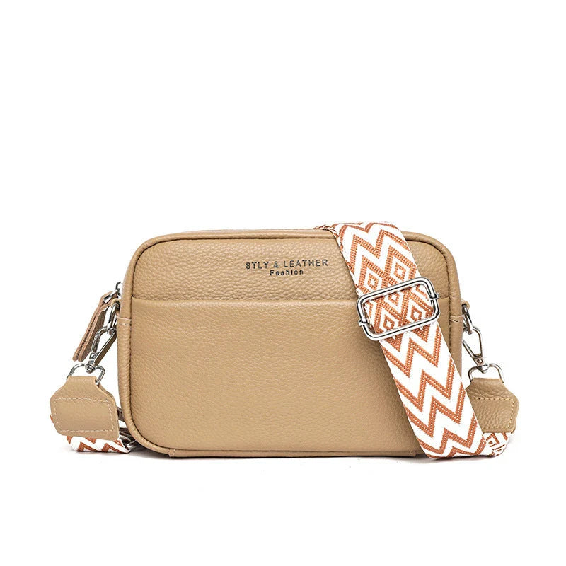 Fashionable leather crossbody bag for women with rhombus embroidered strap, featuring multiple interior pockets and adjustable shoulder strap