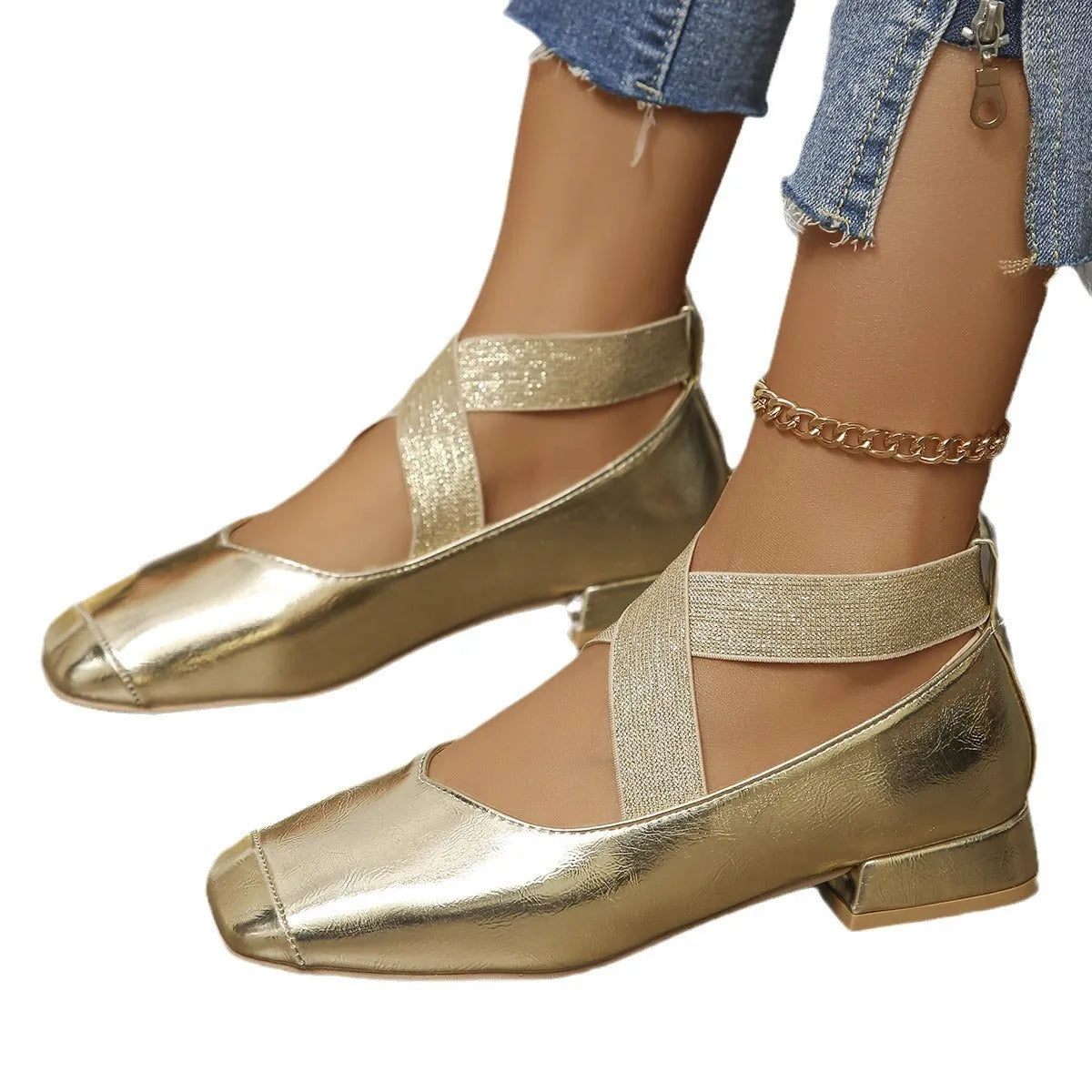 Gold French style slip-on evening pumps with square toe and low heel on a white background
