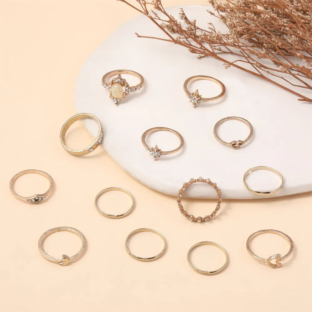 Vintage star and moon 13-piece ring set with opal and rhinestone accents in gold or silver electroplated zinc alloy