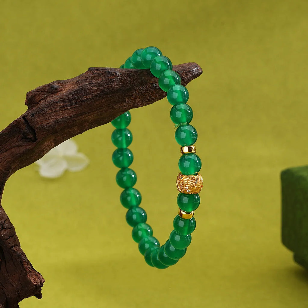 Green agate and sterling silver bracelet with geometric beads and yellow gold plating.