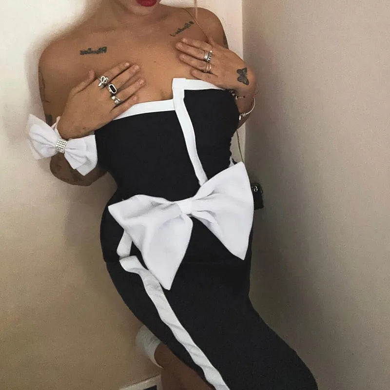 Women's black and white colour-block one-piece swimsuit with asymmetric bow detail
