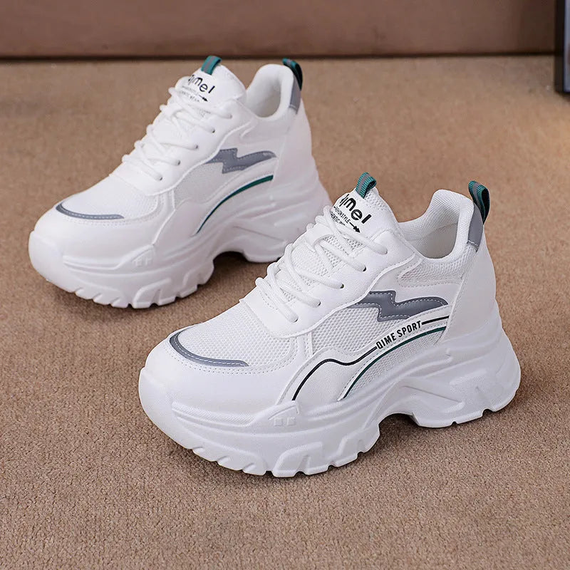 Women's white breathable dad shoes with height increasing insole and lace-up front.
