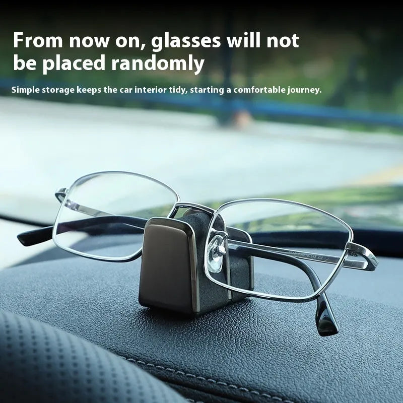 Zinc alloy and leather car dashboard clip for holding sunglasses, shown in green, black, grey, or red.