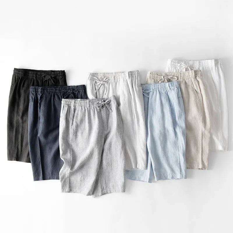 Men's light grey linen trousers with a loose straight-leg fit on a plain background.