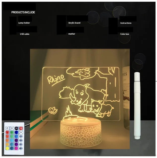 Black 3D acrylic message board lamp with remote control and marker pen on a desk.