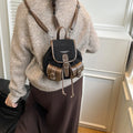 Urban simplicity PU backpack in brown with contrast stitching and clamshell opening, on a flat surface