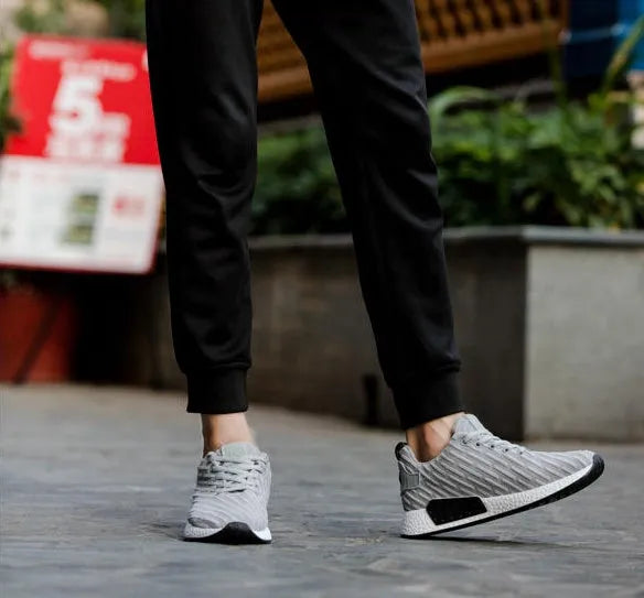 Men Malcolm Sneaker in black from side view showing mesh fabric upper and low-top design