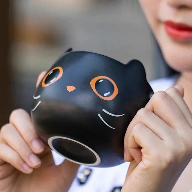 Black ceramic Halloween pumpkin couple mug with 355ml capacity and cat-shaped spoon lid.