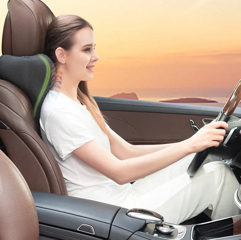 Dark grey car neck memory pillow on a headrest showing its simple rectangular shape.