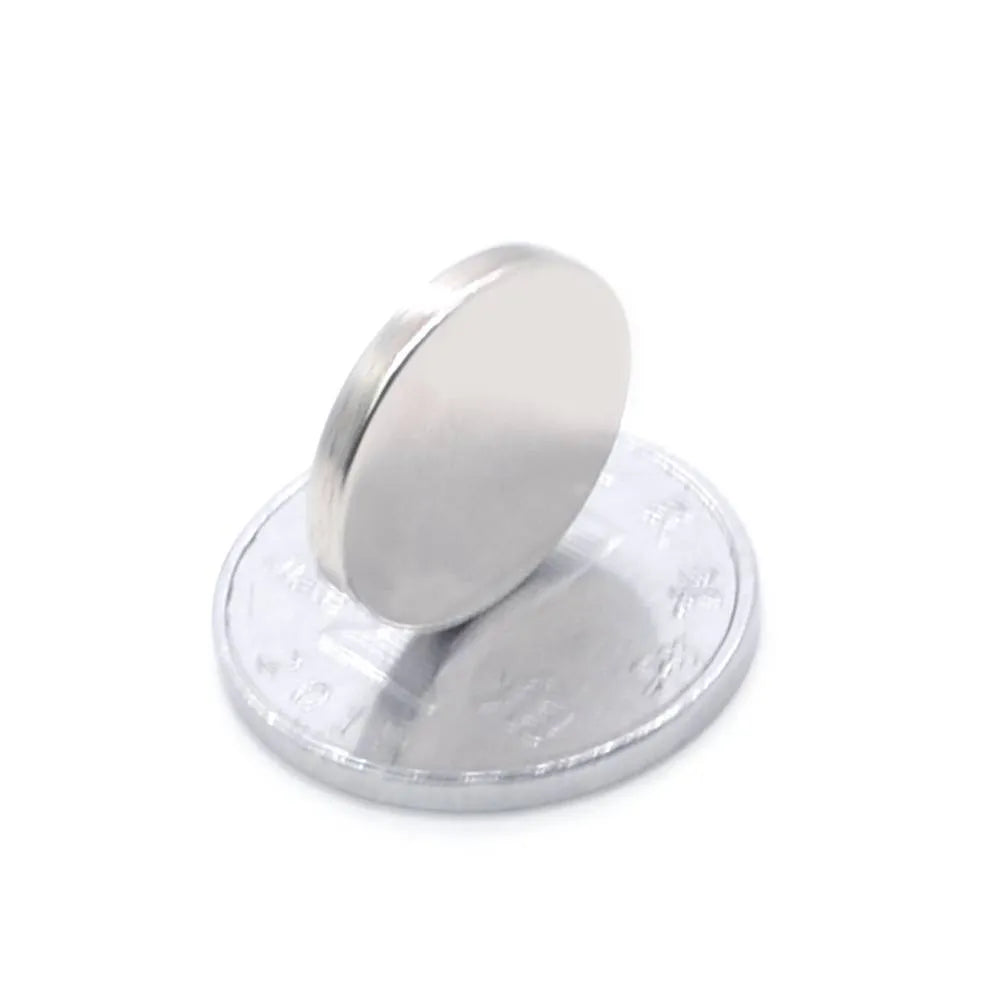 Rare earth NdFeB magnet disc 14x2mm silver N35 grade on white background