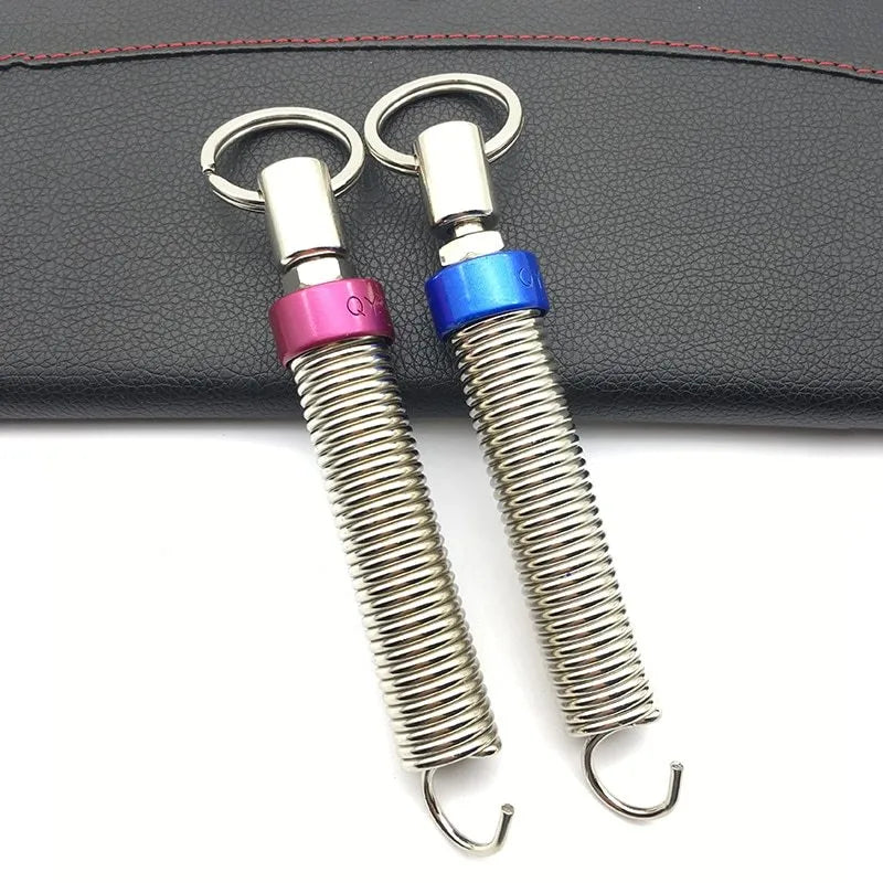 Red car trunk lift spring made from high-strength alloy weighing 130g on a surface