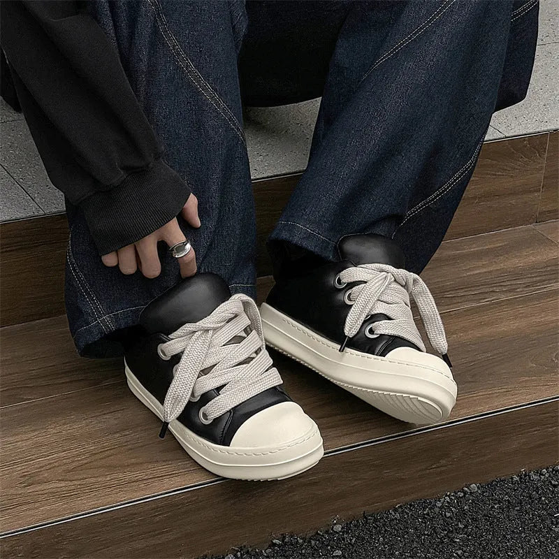 Men's black leather slip-on casual shoes with flat rubber sole and round toe on a white background.