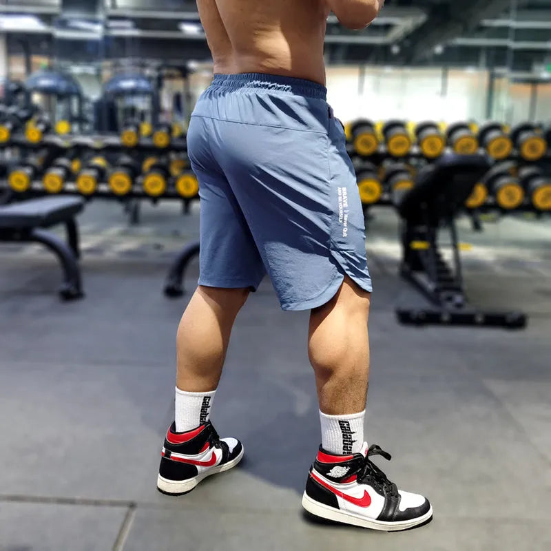 Men's thin quick-drying running shorts in black, blue, or grey, made from nylon and spandex.