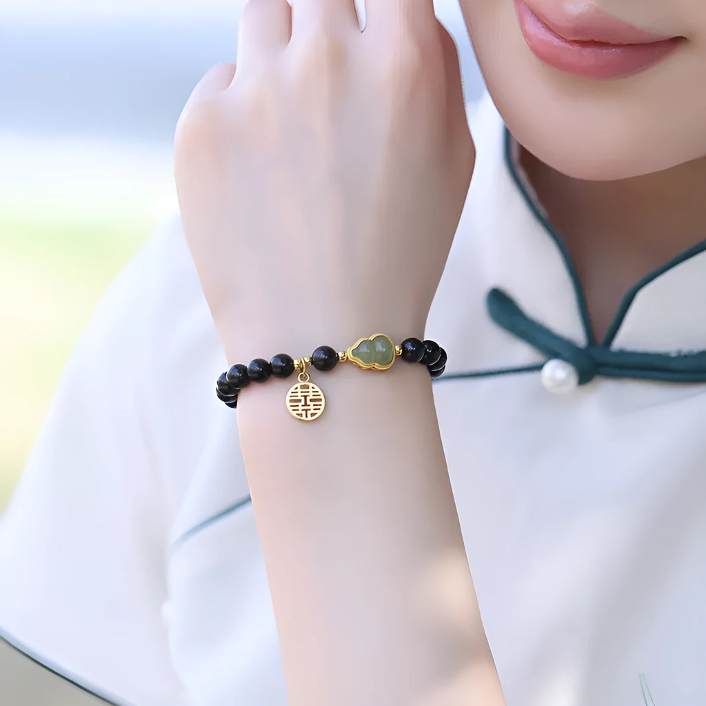 Black obsidian bracelet with Hetian jade gourd charm in geometric pattern