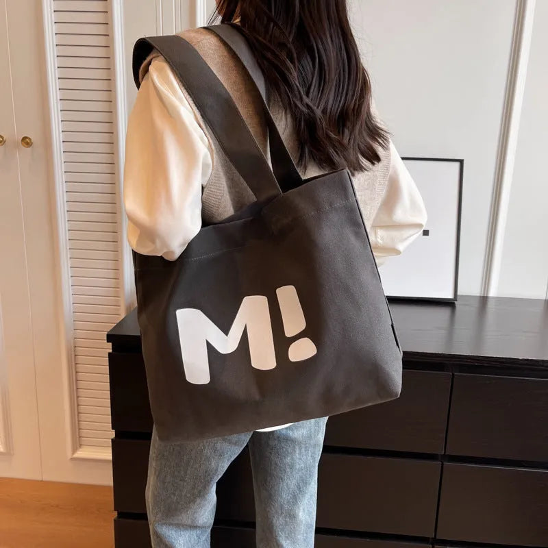 Letter print canvas shoulder bag in dark brown, large capacity tote with shoulder strap for women and girls.