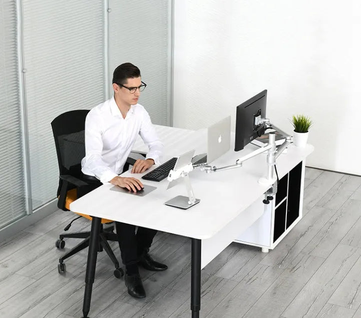 Silver foldable aluminium and ABS phone and tablet stand on a desk, showing 360-degree rotation.