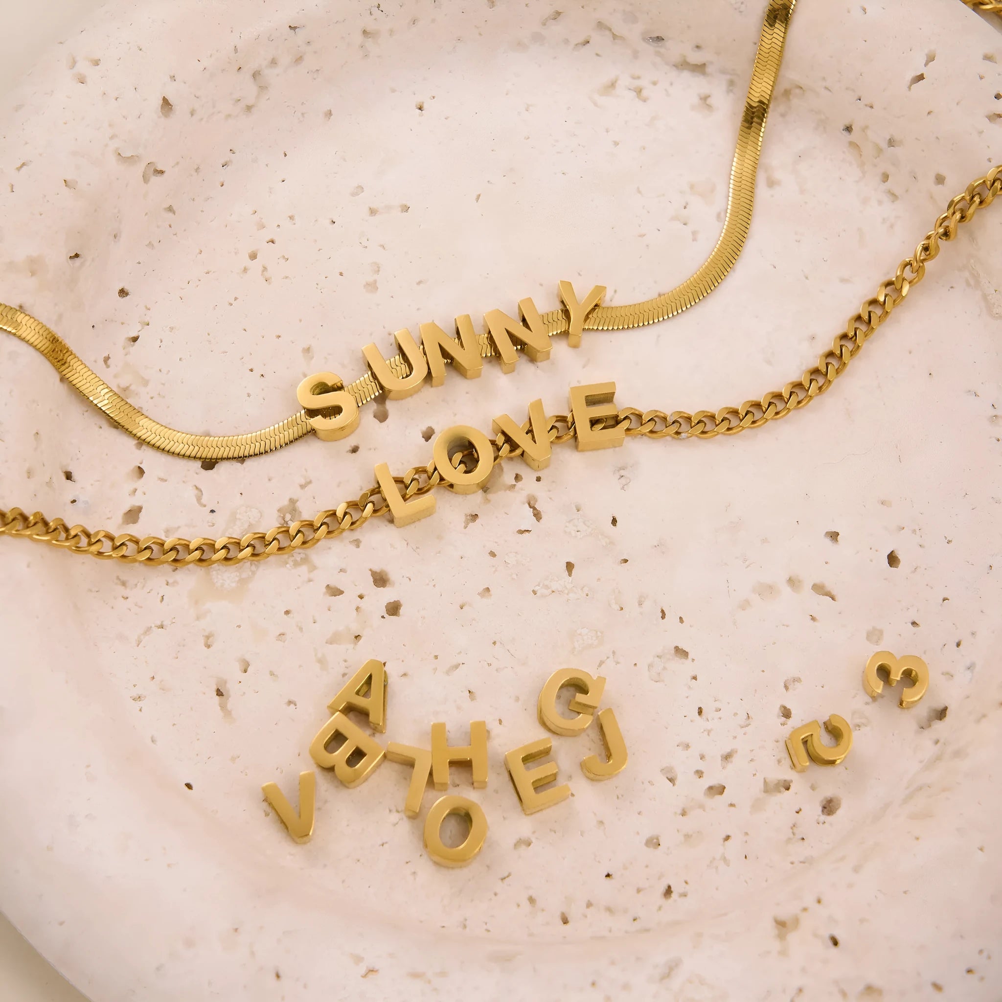 Gold titanium steel necklace with a letter A pendant on a blade chain.