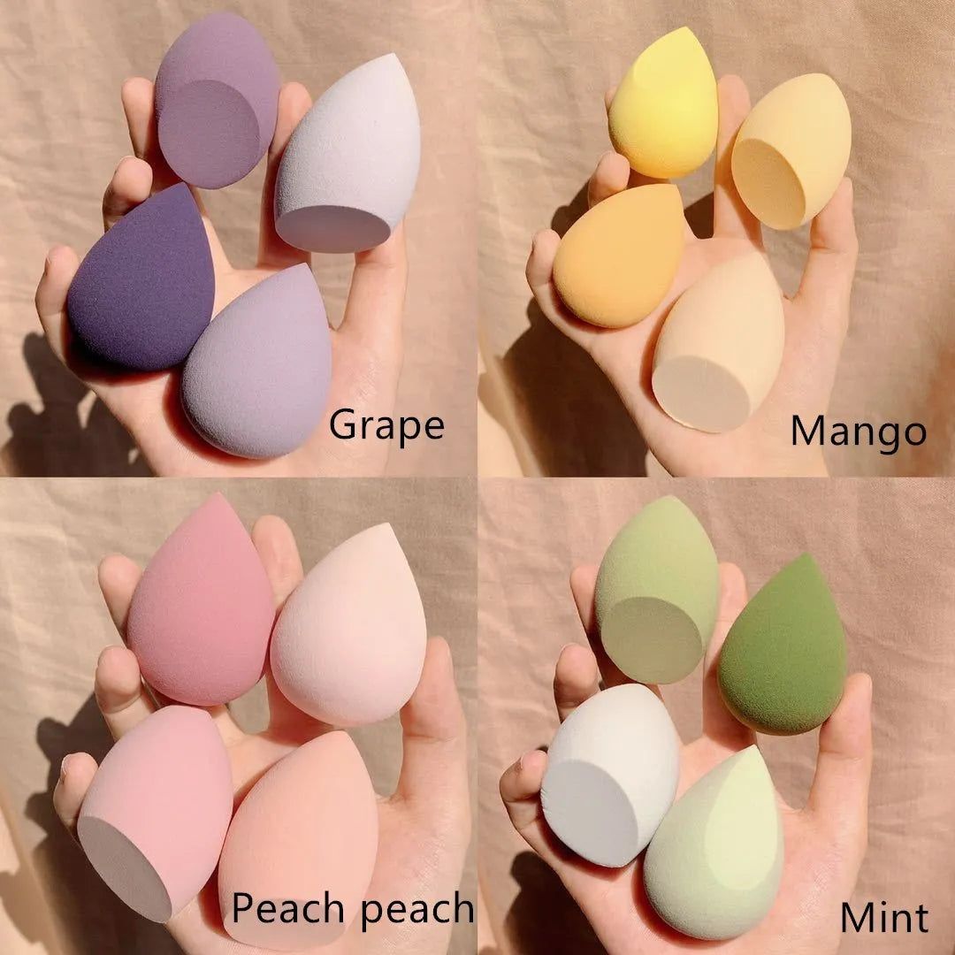 Set of four coloured makeup sponge eggs on a pink background