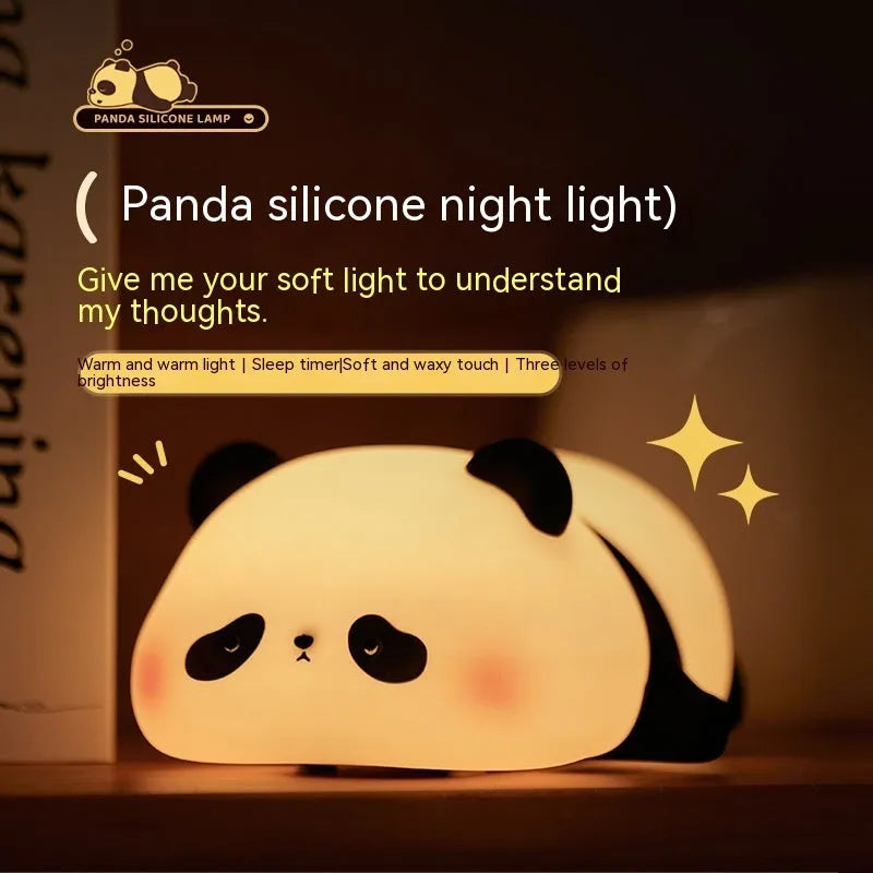 Cute cartoon panda silicone night light for children on a bedside table.