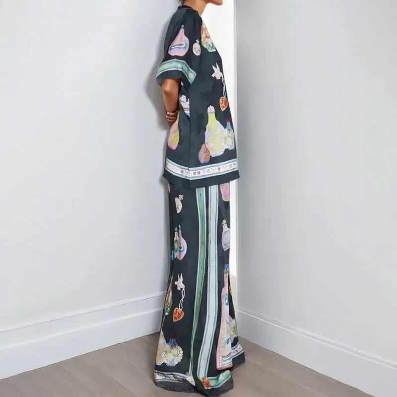 Black women's casual two-piece set with cartoon print, featuring cardigan and matching pants.