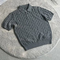 Man wearing a gray knitted short sleeve crew neck t-shirt, casual summer outfit.
