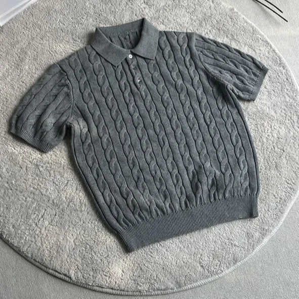 Man wearing a gray knitted short sleeve crew neck t-shirt, casual summer outfit.