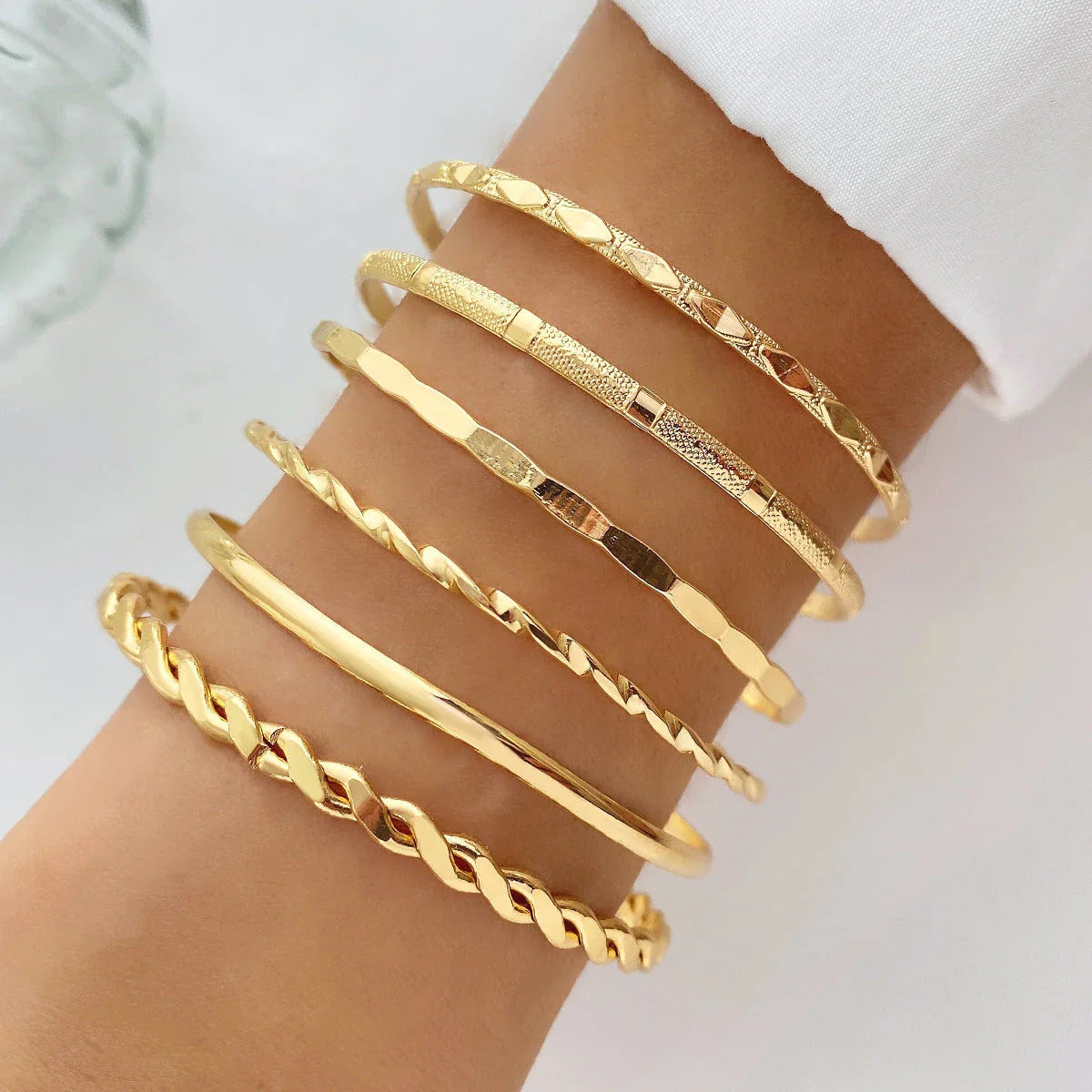 Stylish Bohemian chain bracelets in a gold tone color with geometric shapes, perfect for fashion-forward women