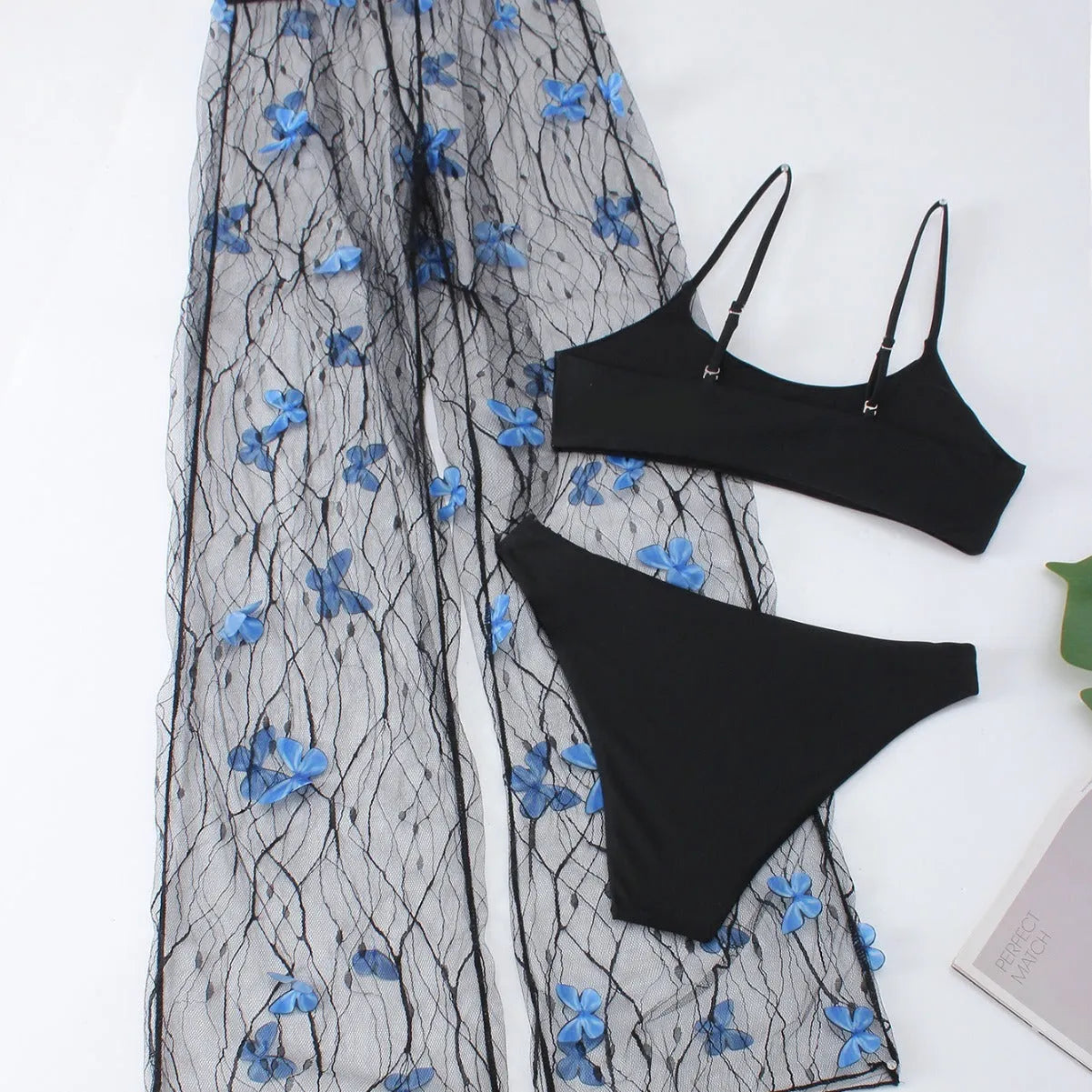 Women's black transparent butterfly pattern bikini three-piece set, showing top, underwear, and pants.